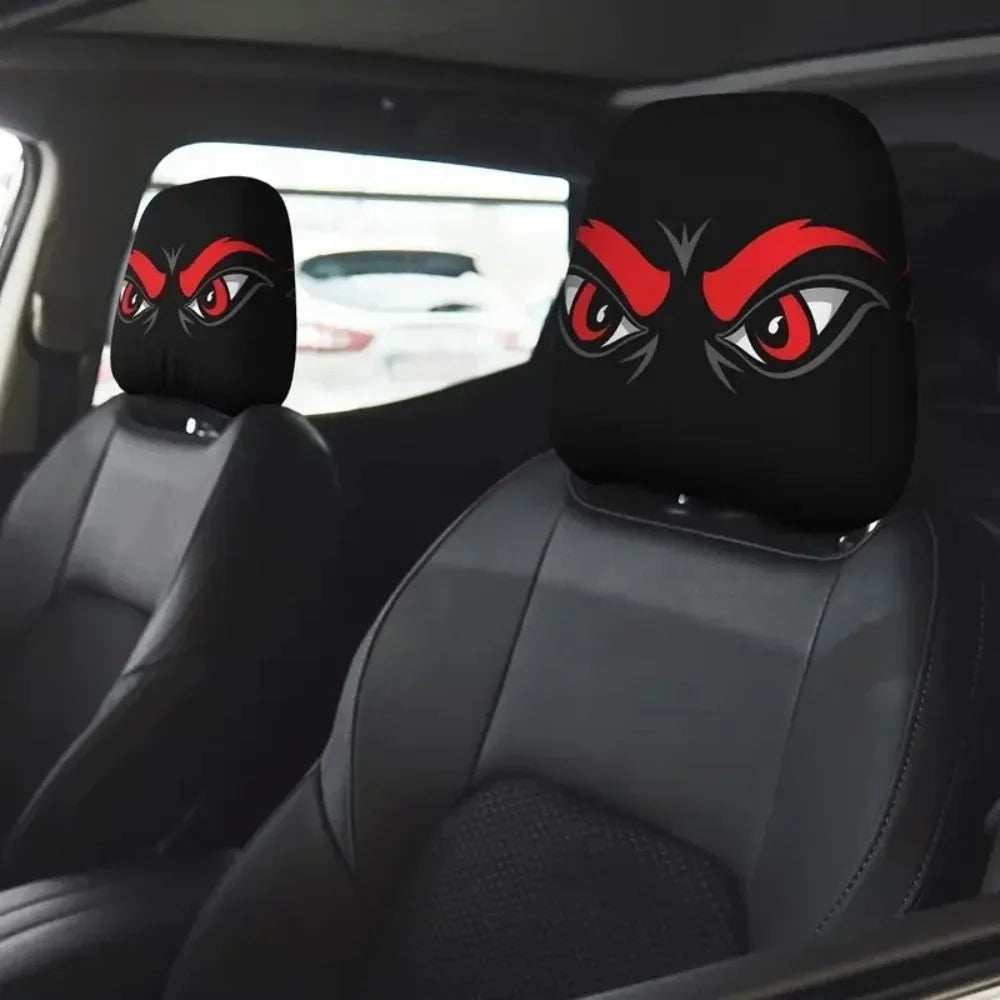 2Pcs Universal Car Seat Cover with black polyester headrest covers featuring bold red and white cartoon eyes