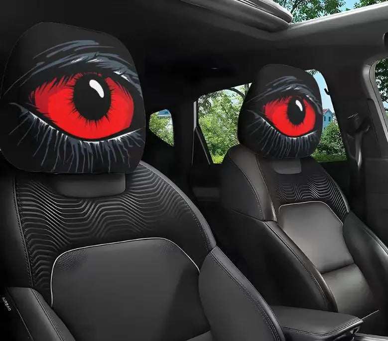 2PCS Universal Fit car headrest covers in black with bold red cartoon eyes and white lashes printed on both sides