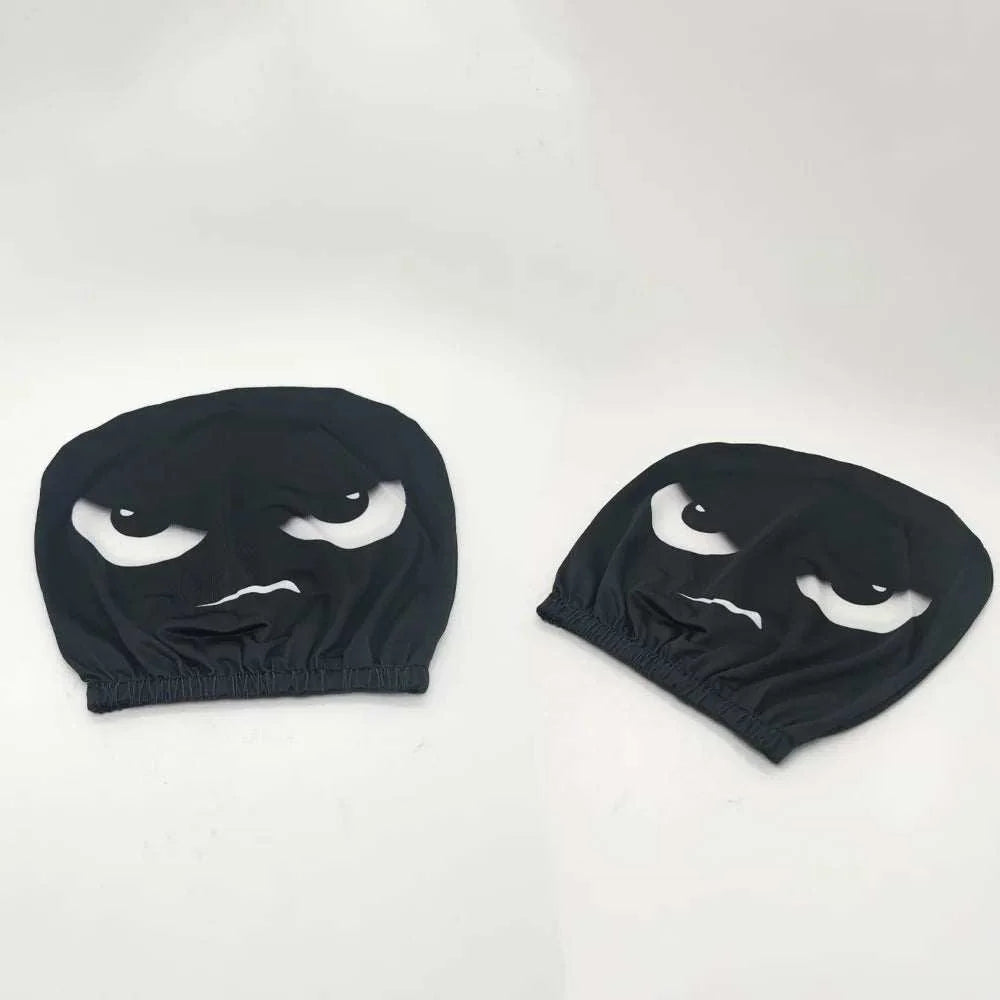 2PCS White Crooked Slant Eyes headrest covers in black fabric with printed white narrowed eyes and a crooked mouth