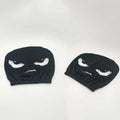 2PCS White Crooked Slant Eyes headrest covers in black fabric with printed white narrowed eyes and a crooked mouth