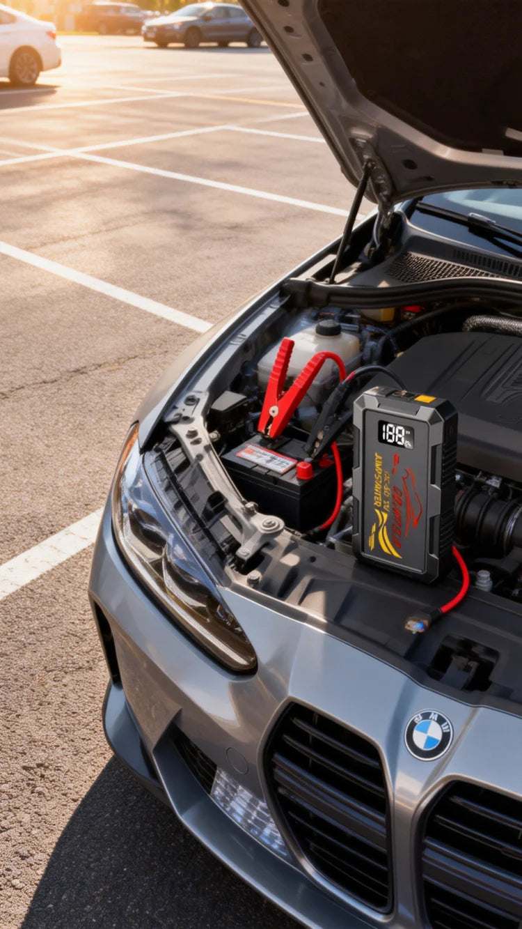 6000A Peak Car Jump Starter, black portable booster with red cables and clamps connected inside a car engine bay
