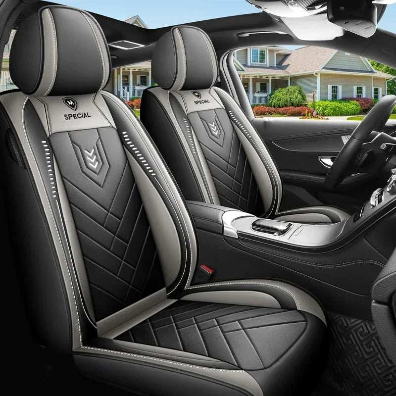 All inclusive seat cover in black and gray leather with diamond stitching, contrasting piping, and padded headrest