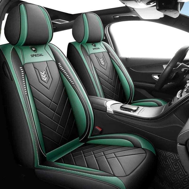 All inclusive seat cover in black and green leather-like material with quilted panels, contrast stitching and headrest coverage