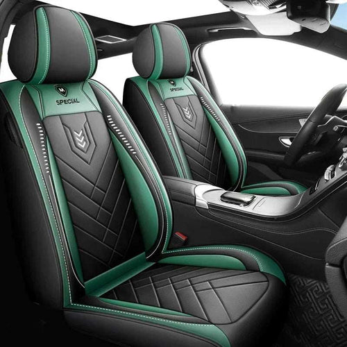 All inclusive seat cover in black and green leather-like material with quilted panels, contrast stitching and headrest coverage