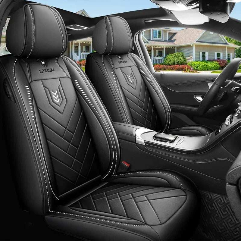 All inclusive seat cover in black leather-look material with quilted panels, white stitching and a fitted design