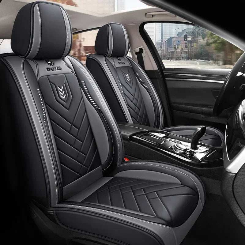All inclusive seat cover in black leather with quilted panels, white piping, and padded full-coverage design