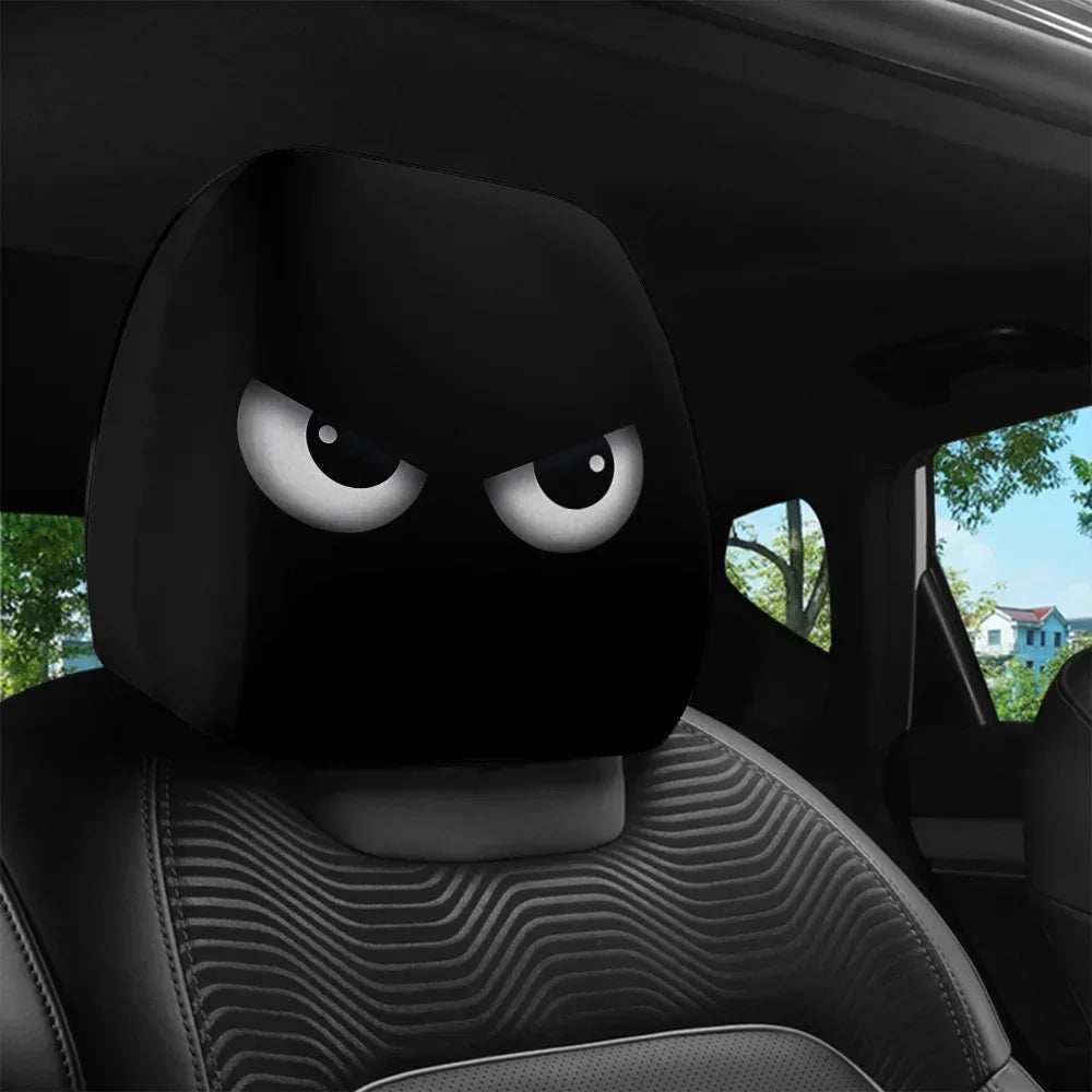 Funny Slanted Eyes black polyester car headrest cover featuring an angry cartoon face with large white eyes