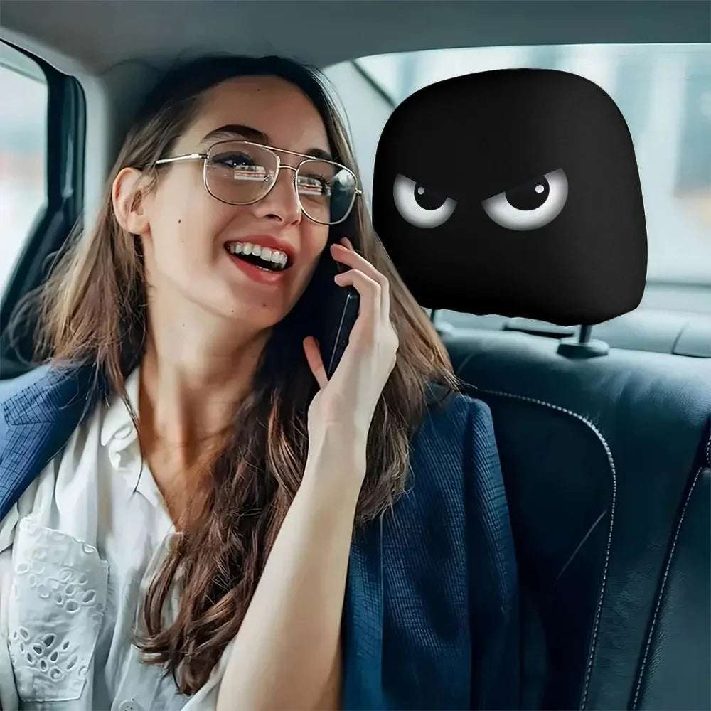 Funny Slanted Eyes black car headrest cover with a cartoon face and white narrowed eyes printed on smooth fabric