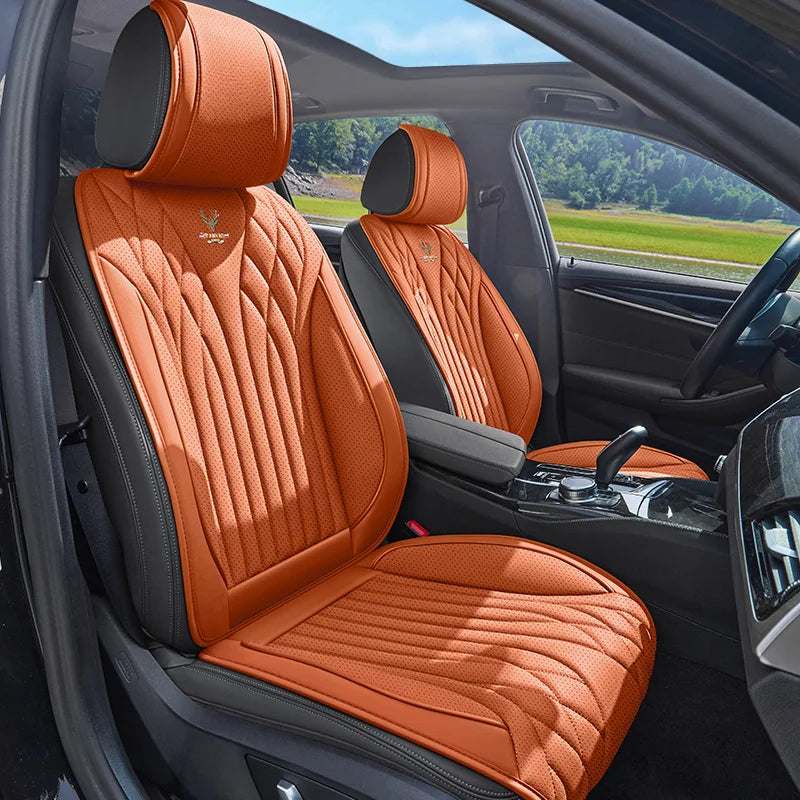 Universal Napa Leather car seat covers in cognac orange with black trim, quilted panels, and matching headrest covers